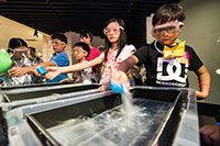 Participants of the Alien Party @ Space Museum learn the structure of a comet through a demonstration.